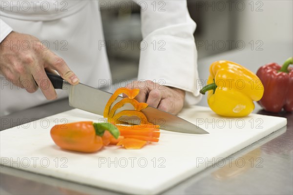 Chef chopping bell peppers. Date : 2008