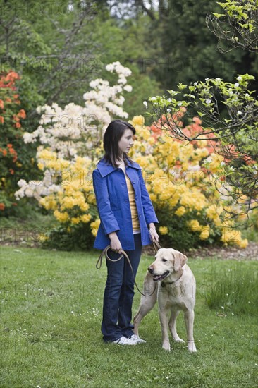 Girl walking dog in park. Date : 2008