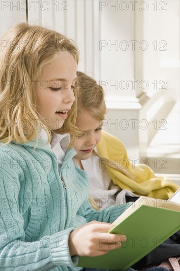 Sisters reading on porch. Date : 2008