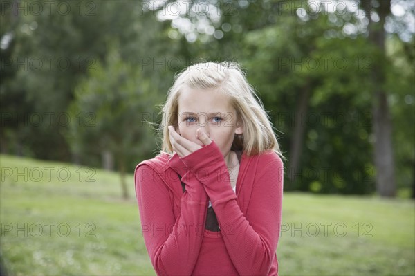 Girl blowing on cold hands. Date : 2008