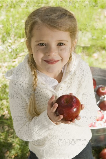 Girl bobbing for apples. Date : 2008