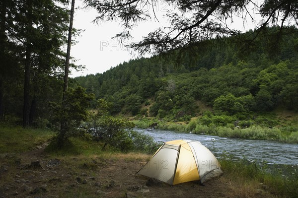 Tent and campsite by river. Date : 2008