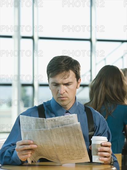 Businessman reading newspaper. Date : 2008