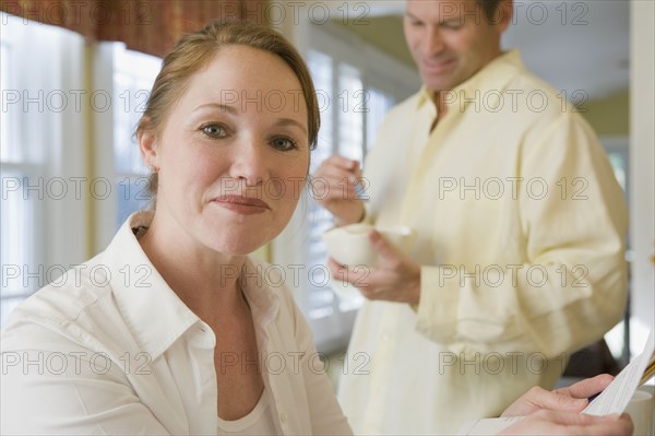 Couple beginning day in kitchen. Date : 2008