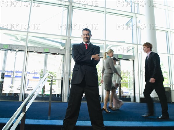 Confident businessman posing in lobby. Date : 2008