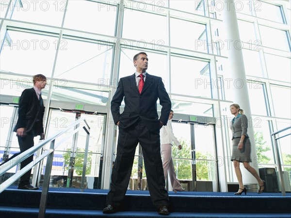 Confident businessman posing in lobby. Date : 2008