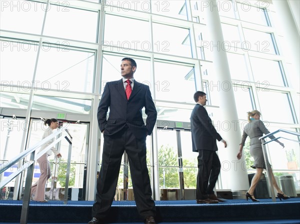 Confident businessman posing in lobby. Date : 2008