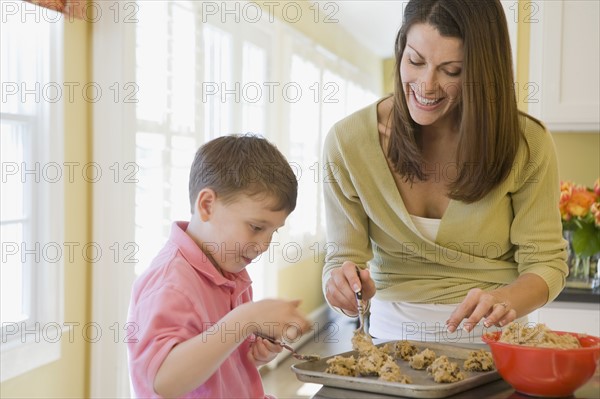 Mother and son making cookies. Date : 2008