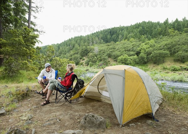 Couple relaxing at campsite. Date : 2008