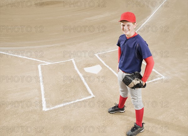 Baseball player in uniform posing by home plate. Date : 2008