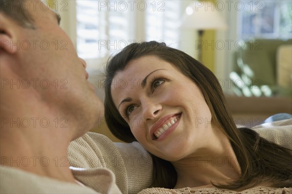 Couple relaxing in livingroom. Date : 2008