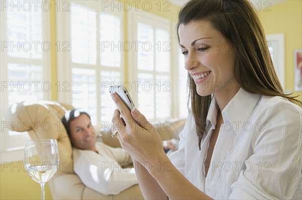 Couple relaxing in livingroom. Date : 2008