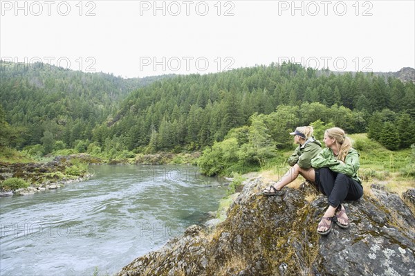 Hikers enjoying view of river. Date : 2008