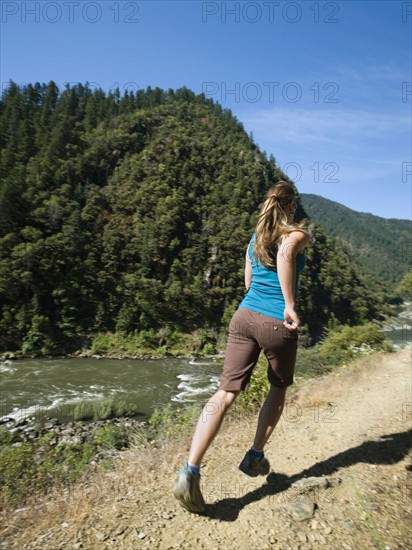 Woman running on riverside trail. Date : 2008