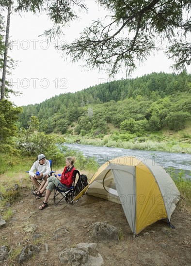 Couple relaxing at campsite. Date : 2008