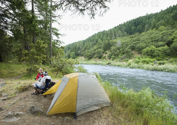 Couple relaxing at campsite. Date : 2008