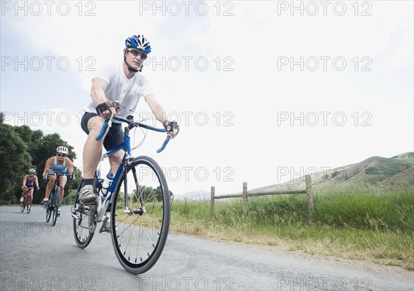 Cyclists in a row on country road. Date : 2008