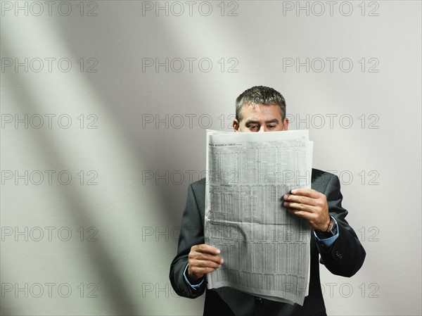 Businessman reading newspaper. Date : 2008