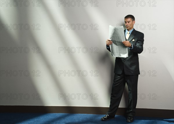 Businessman reading newspaper. Date : 2008