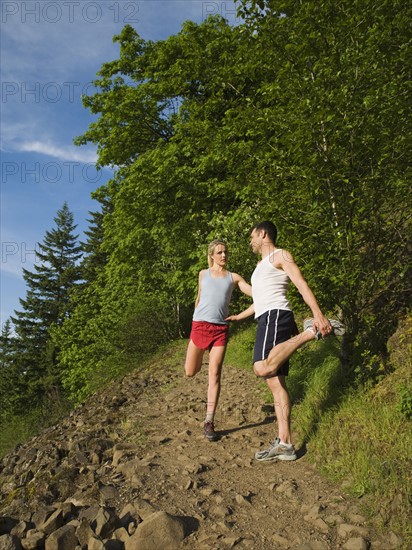 Runners stretching on rocky trail. Date : 2008