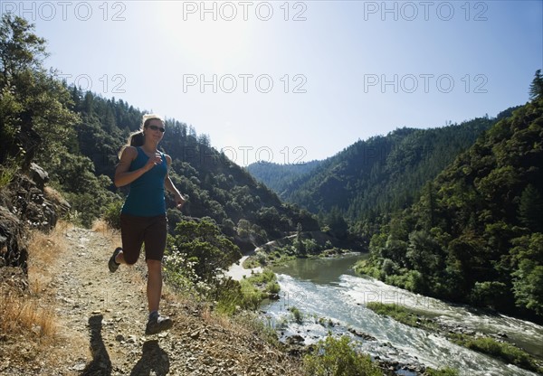 Woman running on riverside trail. Date : 2008