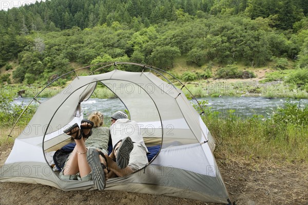 Couple relaxing in tent. Date : 2008