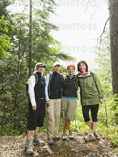 Female hikers posing in forest. Date : 2008