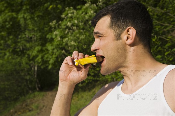 Man eating energy bar. Date : 2008