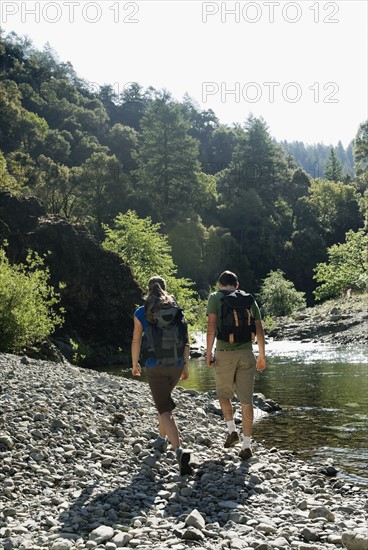 Hikers walking along river. Date : 2008