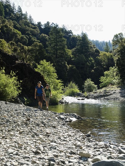 Hikers walking along river. Date : 2008