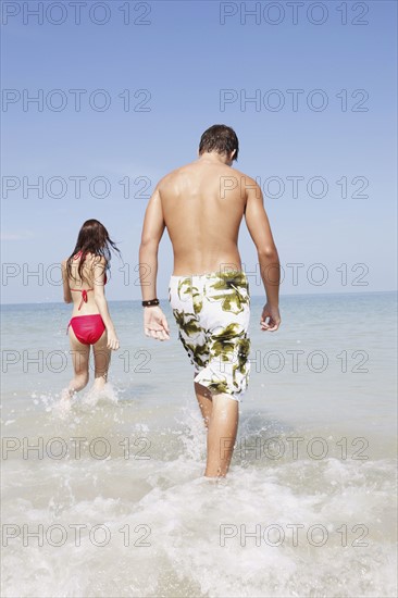 Friends walking in ocean. Date : 2008