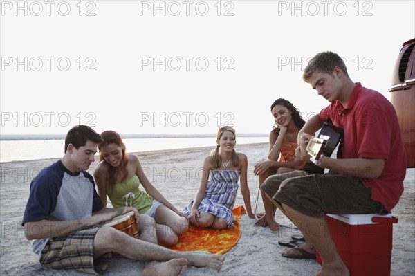 Friends socializing on beach. Date : 2008