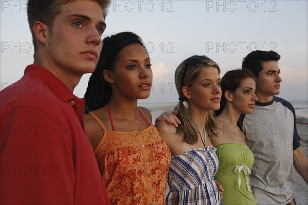 Friends watching sunset on beach. Date : 2008