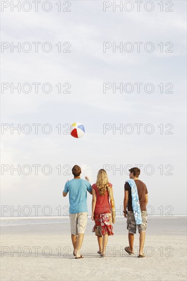Friends walking on beach. Date : 2008