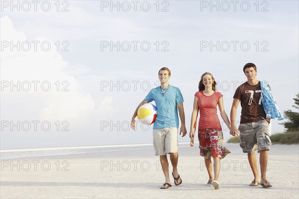 Friends walking on beach. Date : 2008