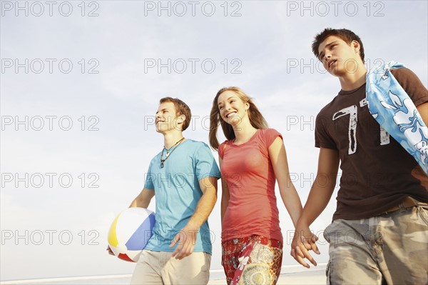 Friends walking on beach. Date : 2008