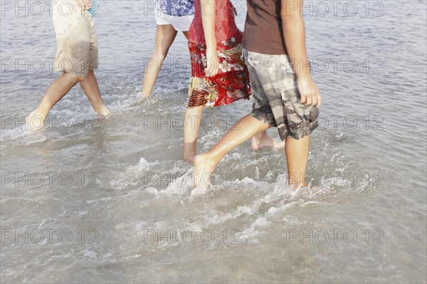 Friends wading in ocean. Date : 2008
