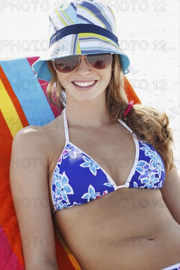 Teenage girl relaxing on beach. Date : 2008