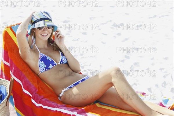 Teenage girl relaxing on beach. Date : 2008