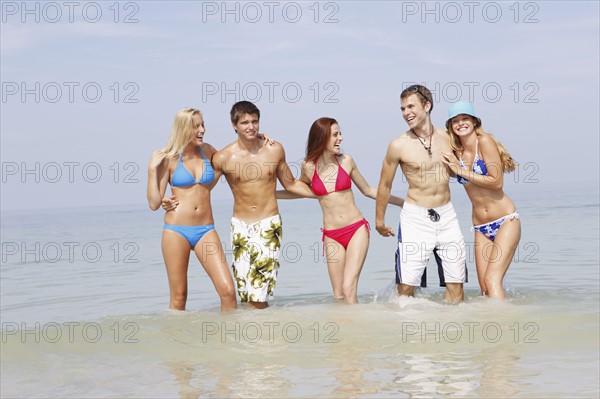 Friends wading in ocean. Date : 2008