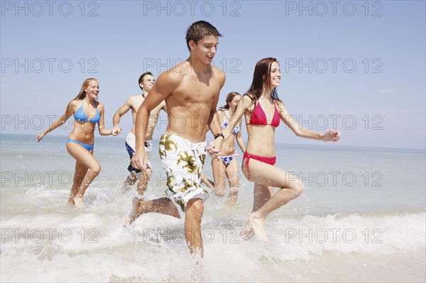 Friends running in ocean. Date : 2008