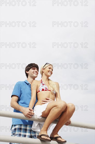 Young couple hugging on boardwalk railing. Date : 2008