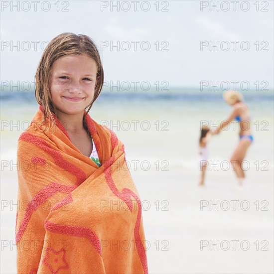Girl wrapped in towel on beach. Date : 2008