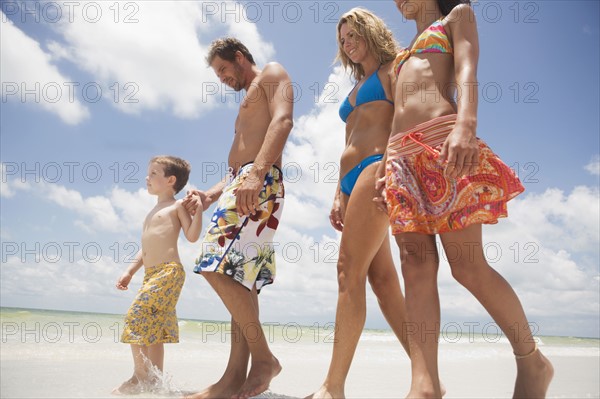 Family walking on beach. Date : 2008