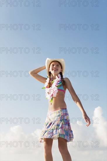 Girl in bathing suit with lei around neck. Date : 2008