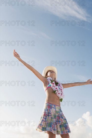 Girl in bathing suit with lei around neck. Date : 2008