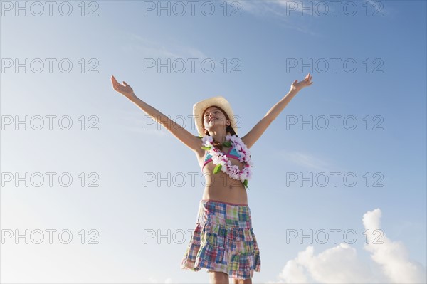 Girl in bathing suit with lei around neck. Date : 2008