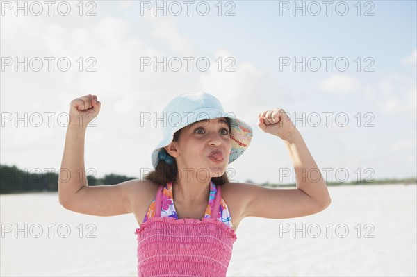 Girl at beach making funny face. Date : 2008