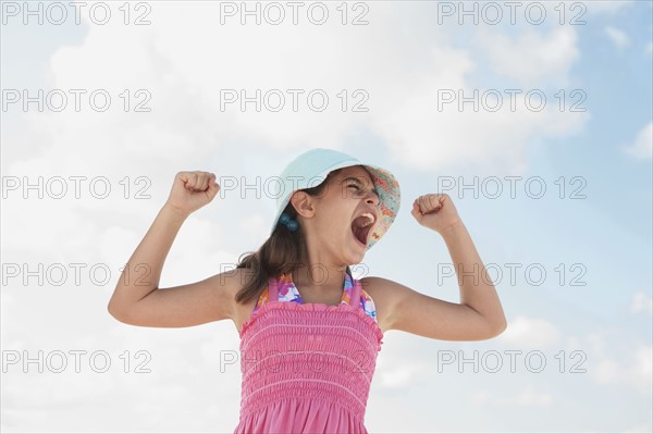 Girl at beach making funny face. Date : 2008