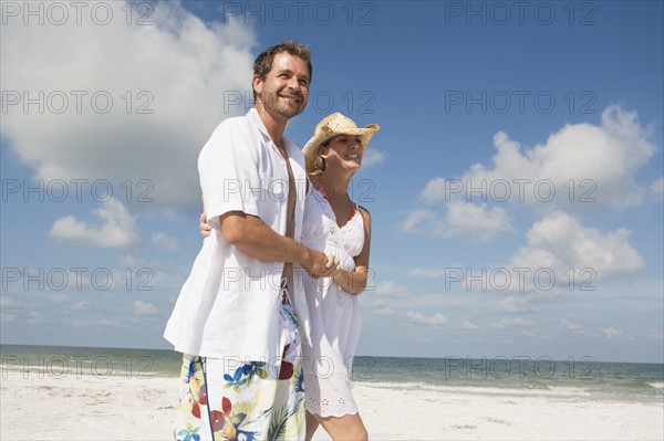 Couple walking on beach. Date : 2008